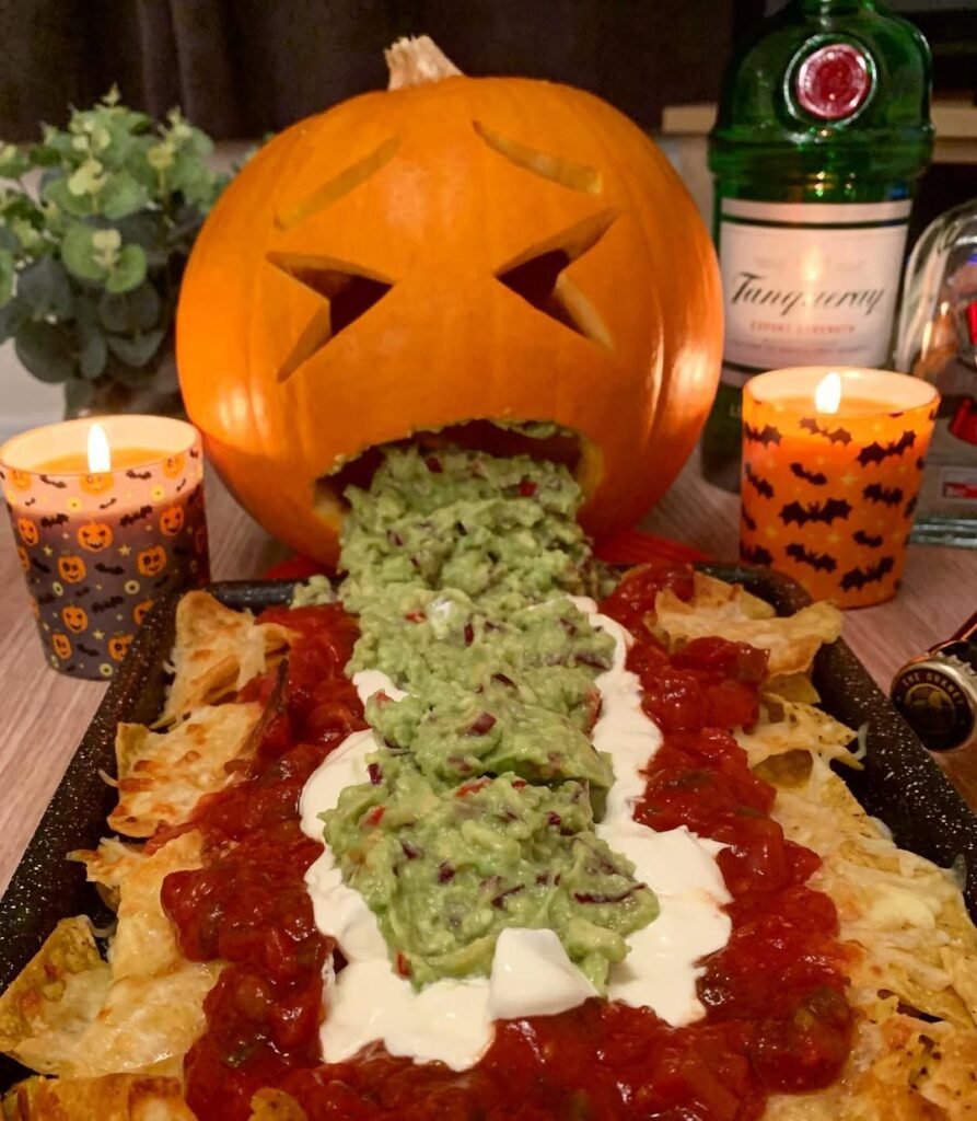 7 Best Spooky Halloween Party Appetizers 4 A bowl of guacamole dip decorated with ghost-shaped cheese and tortilla chips.