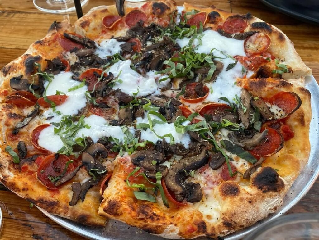 13 Easy And Delicious Grandma Pizza Recipes You Need To Try 2 Delicious pepperoni and mushroom pizza on a wooden table