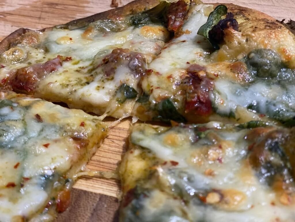 13 Easy And Delicious Grandma Pizza Recipes You Need To Try 9 A delicious pizza topped with pesto, sun-dried tomatoes, and fresh basil.