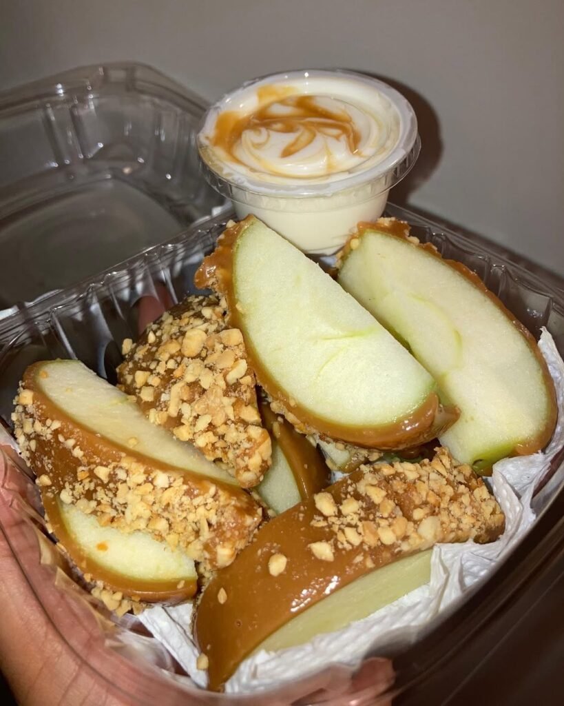 12 Best Halloween Desserts 11 Plate of caramel apple slices topped with nuts, perfect for Halloween.