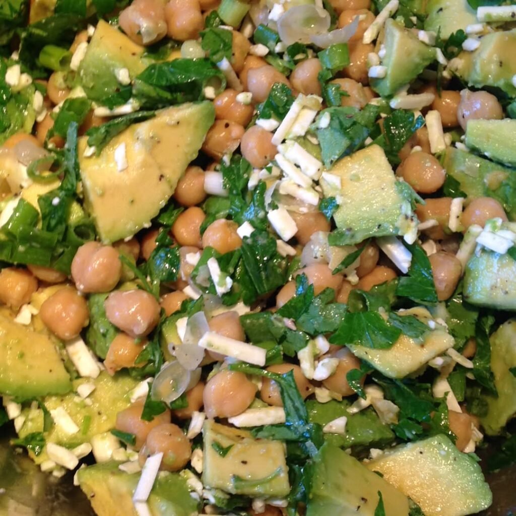 Chickpea salad with avocado dressing in a wooden bowl