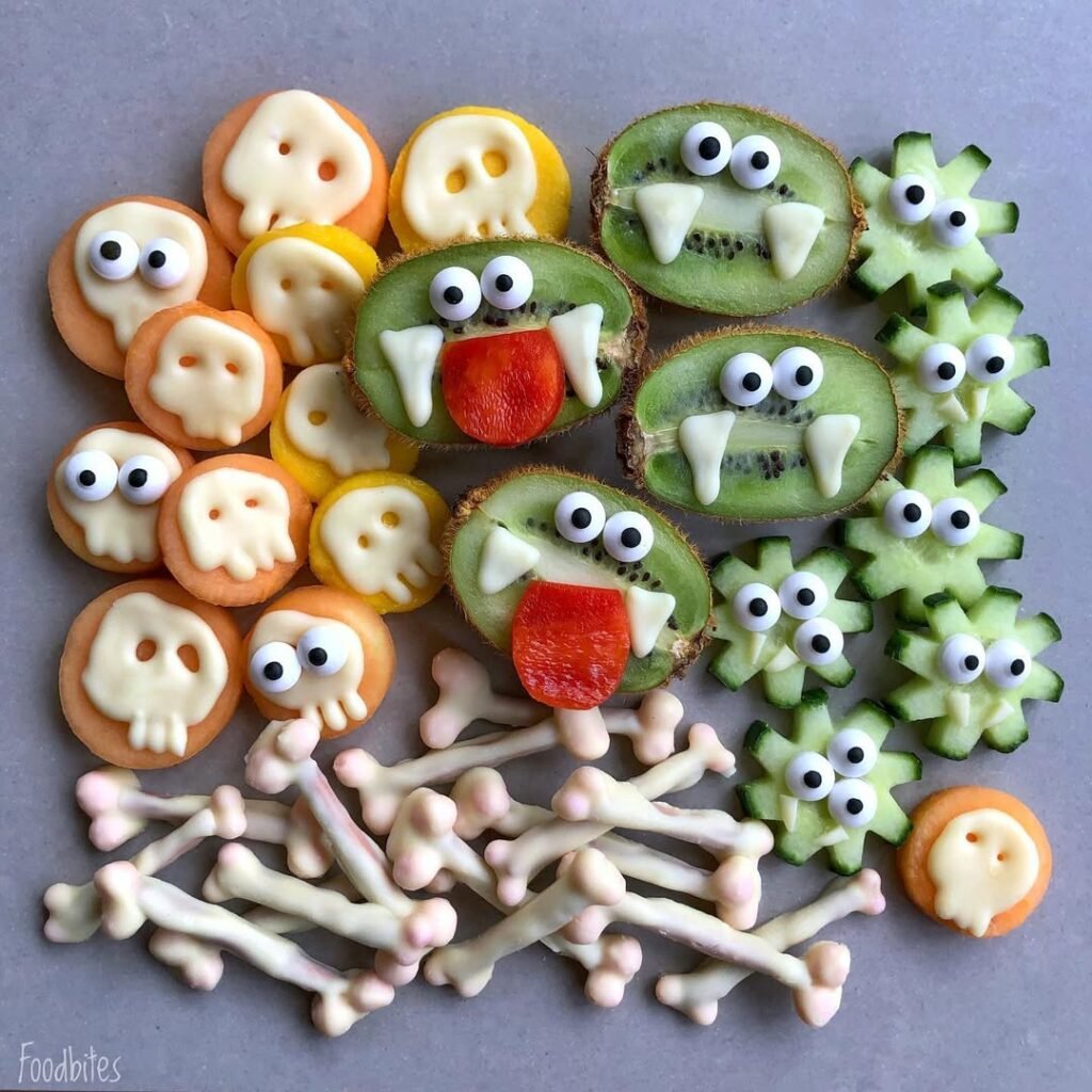 9 Best Halloween Party Treats Sure To Spook Your Guests 10 A plate of chocolate-dipped pretzel bones, featuring dark and white chocolate-covered pretzels arranged with Halloween decorations.