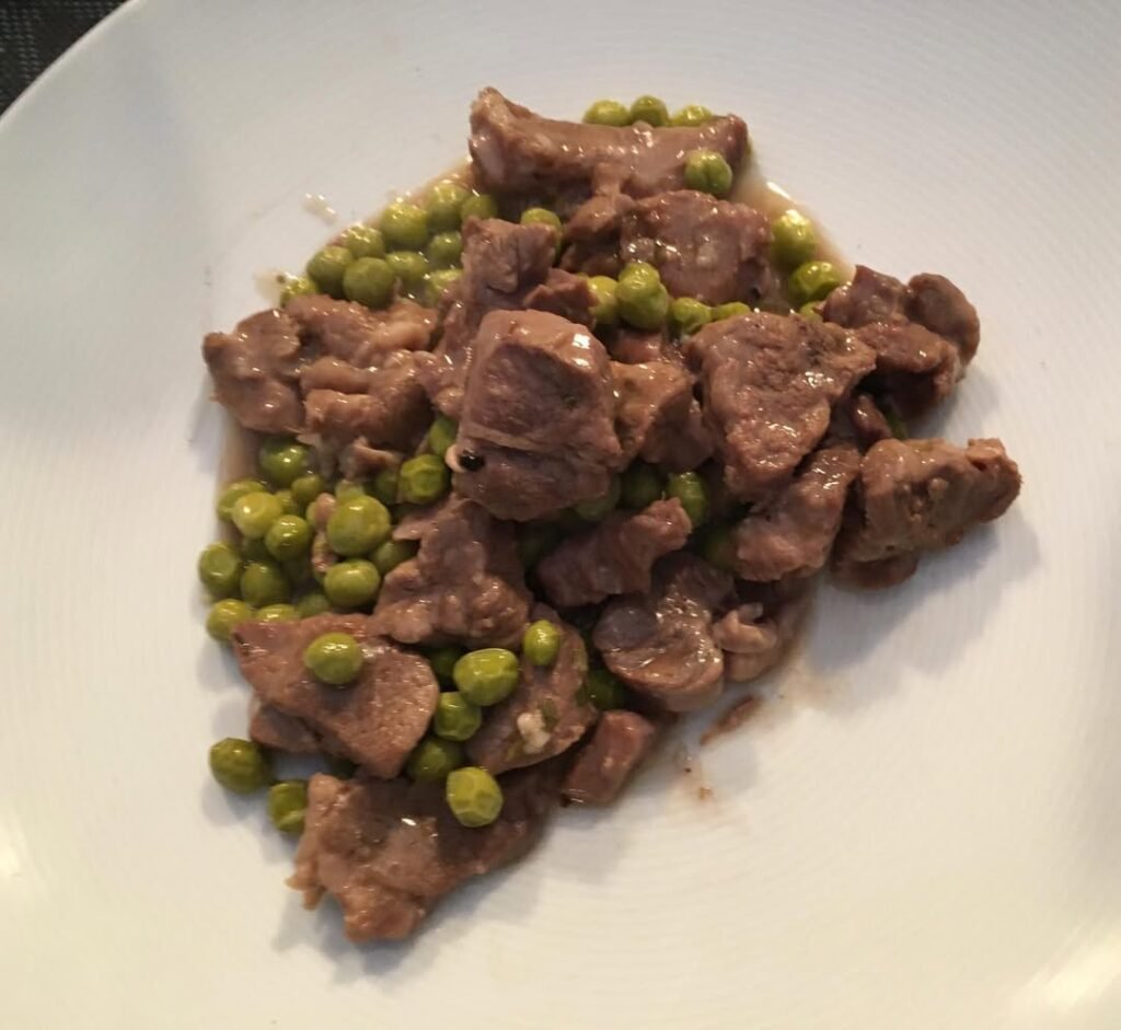 bowl filled with lamb and peas.