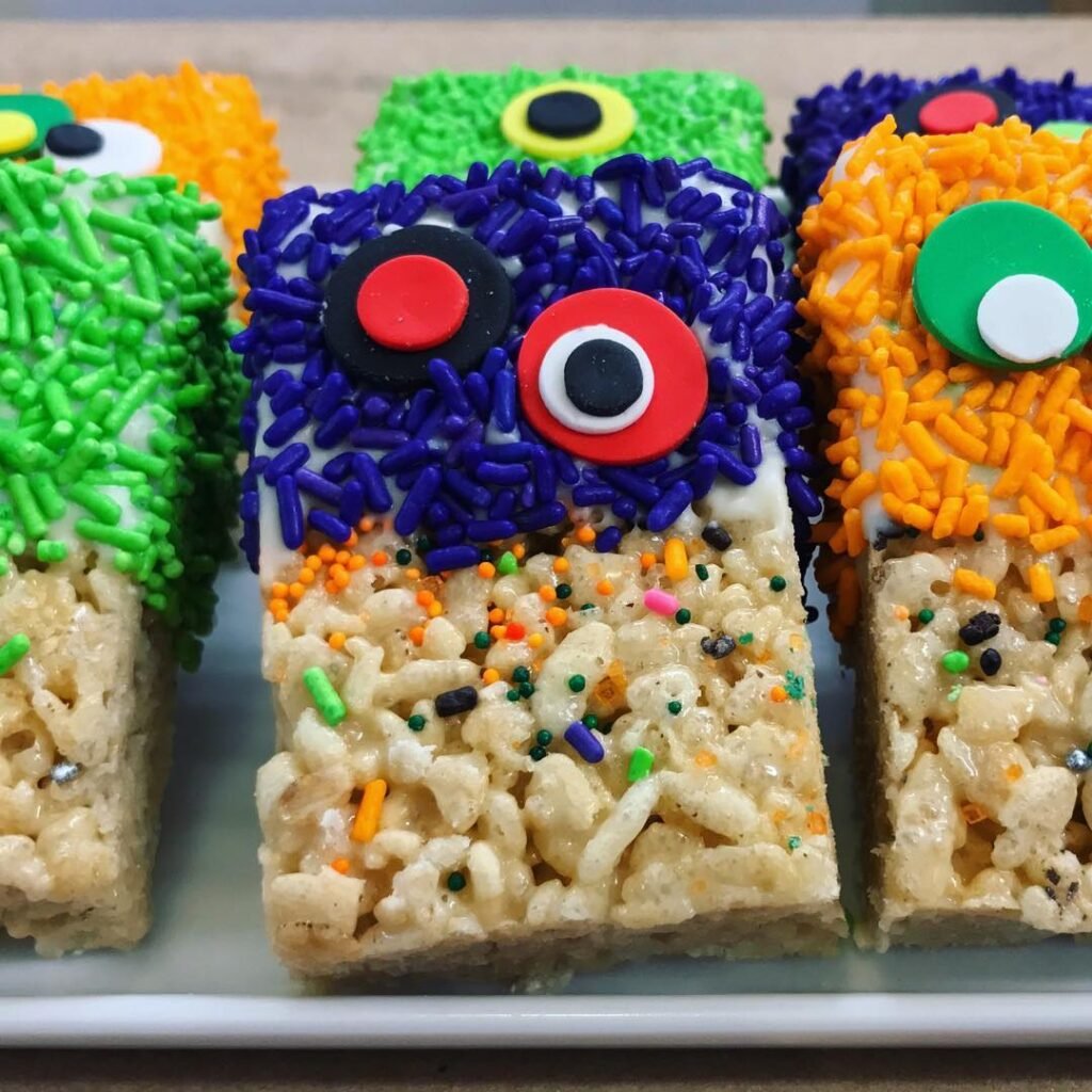 9 Best Halloween Party Treats Sure To Spook Your Guests 4 Colorful Monster Rice Krispie Treats decorated with frosting and candy eyes