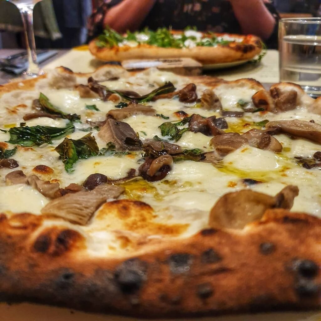 A delicious mushroom pizza topped with truffle oil and fresh herbs.