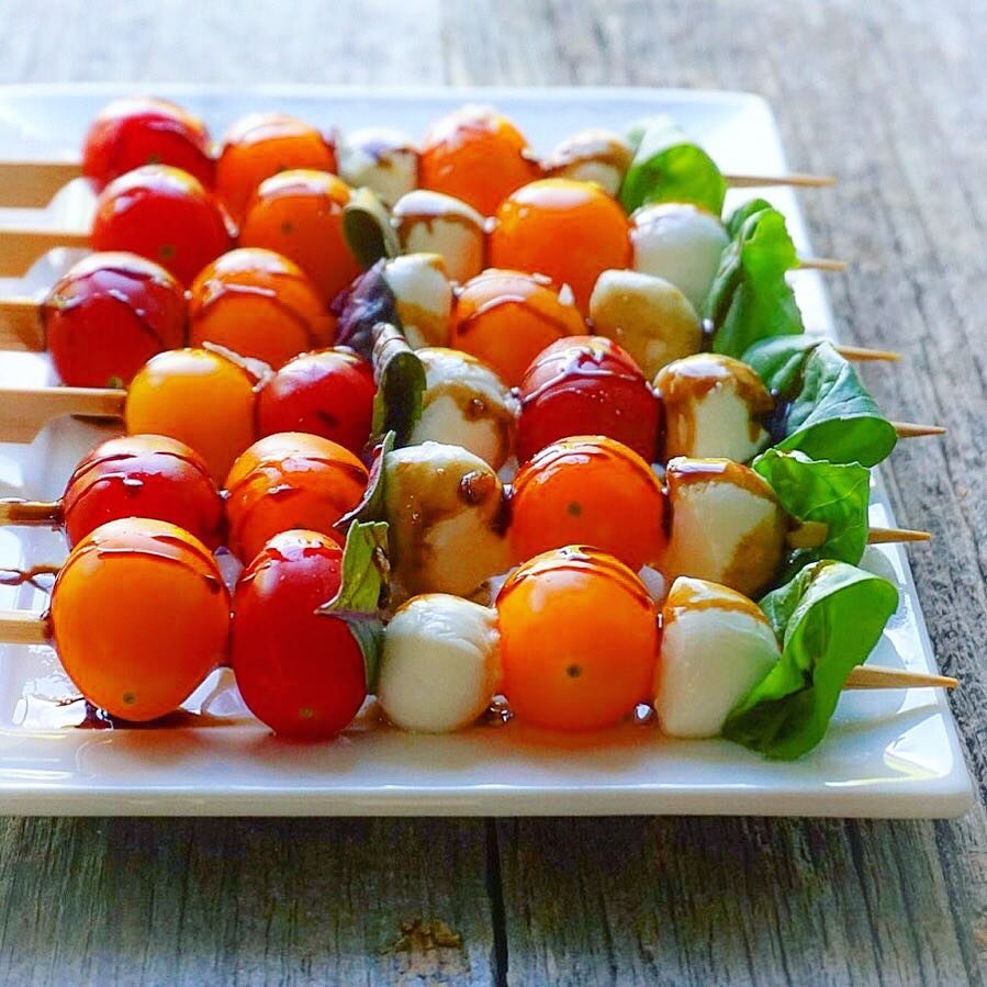 Caprese salad skewers with cherry tomatoes, mozzarella, and basil