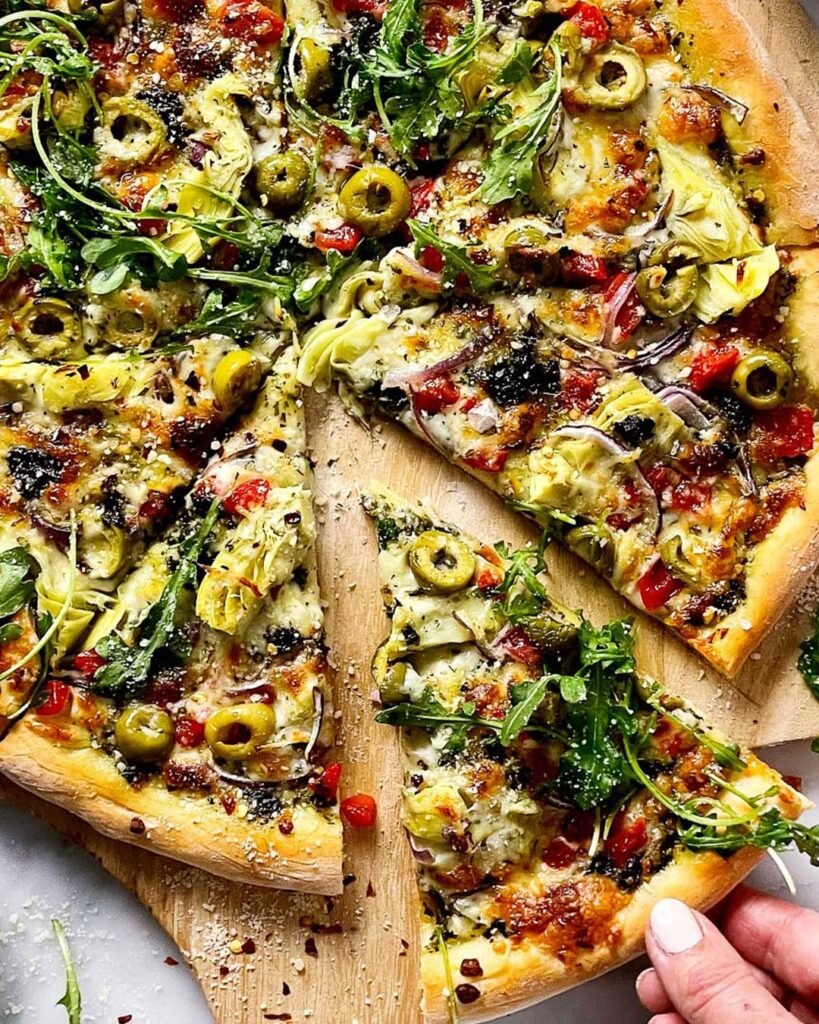 Mediterranean Veggie pizza topped with feta cheese, olives, and colorful vegetables