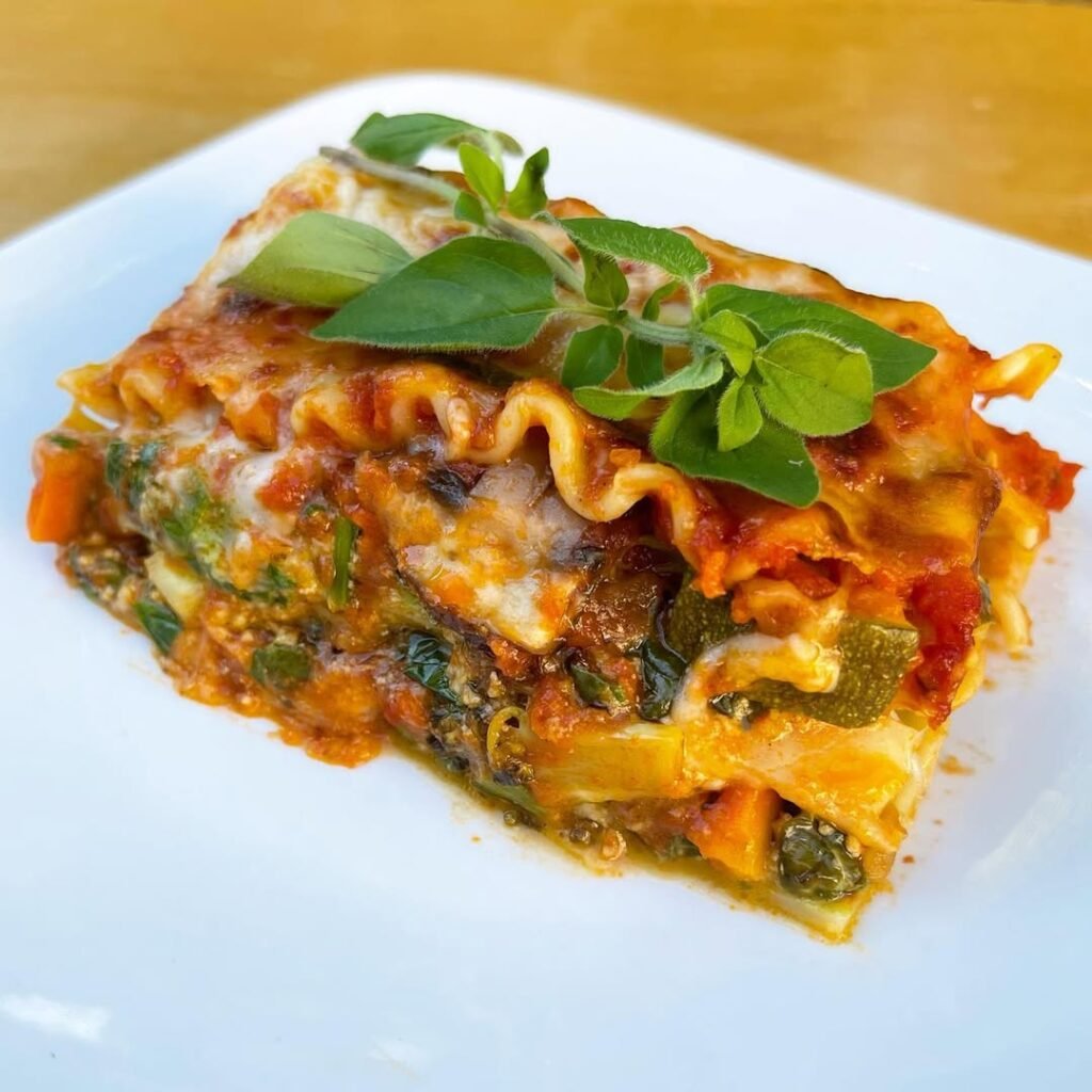 10 Delicious Vegetarian Pasta Recipes to Savor 9 A delicious roasted vegetable lasagna with layers of pasta, cheese, and colorful vegetables.