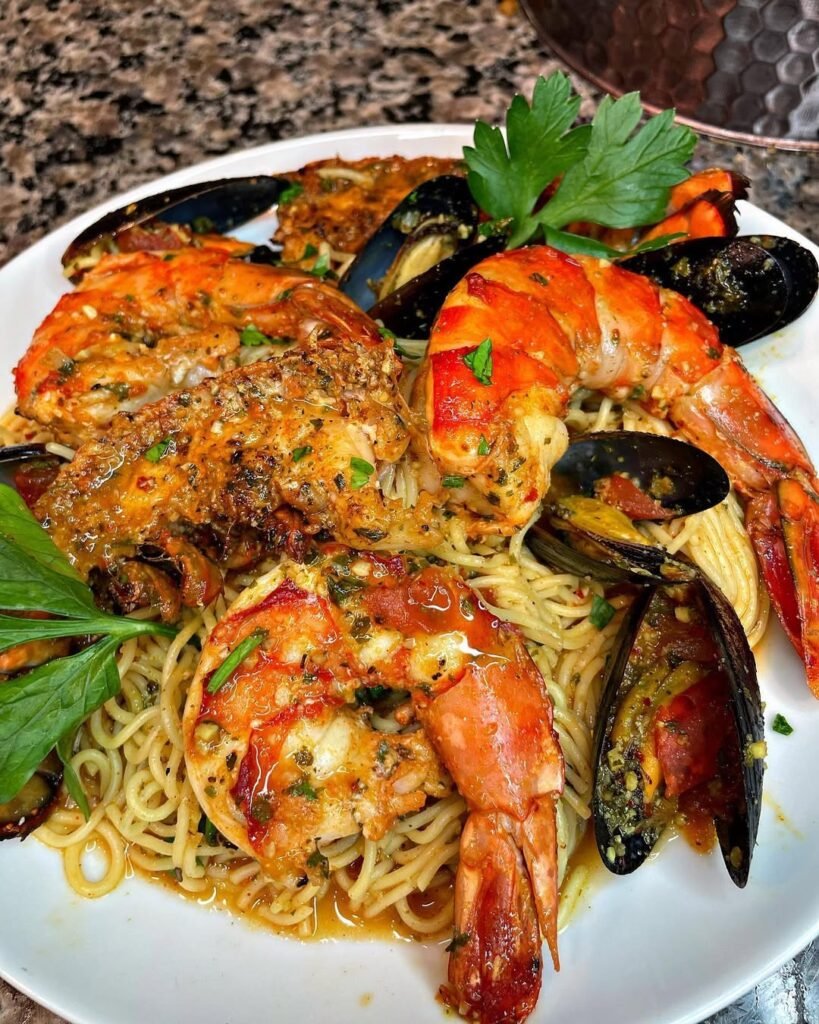 10 Lobster Dinner Recipes For A Taste Of Luxury 4 A bowl of lobster and shrimp scampi linguine garnished with parsley.