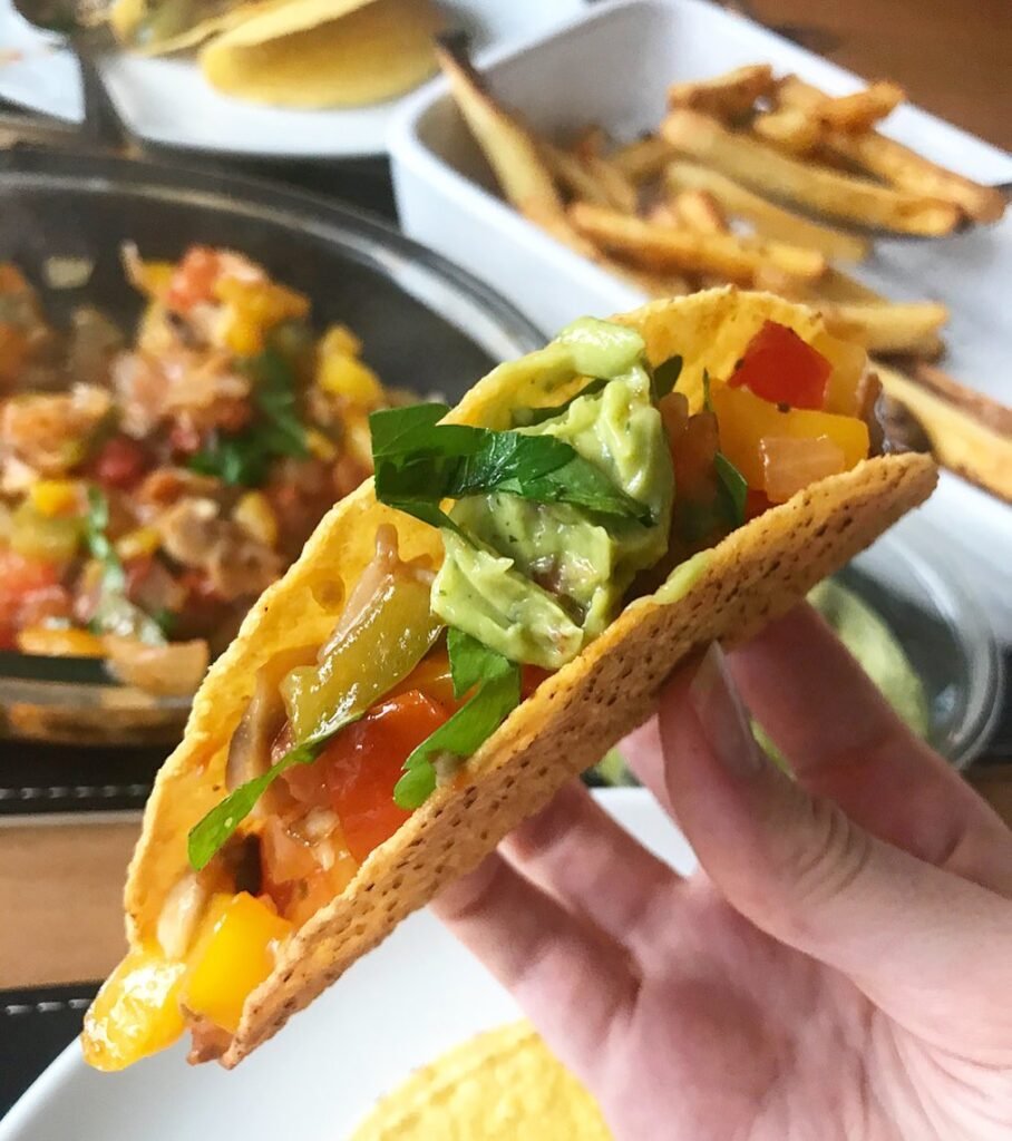 8 Meatless Monday Recipes To Try Tonight 6 Roasted vegetable tacos with avocado salsa on wooden table