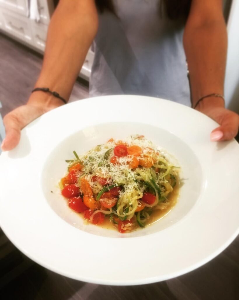 8 Meatless Monday Recipes To Try Tonight 2 A plate of zucchini noodles topped with pesto, cherry tomatoes, and pine nuts.