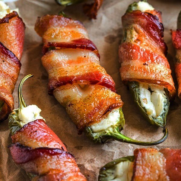 Bacon-wrapped jalapeño poppers on a baking sheet