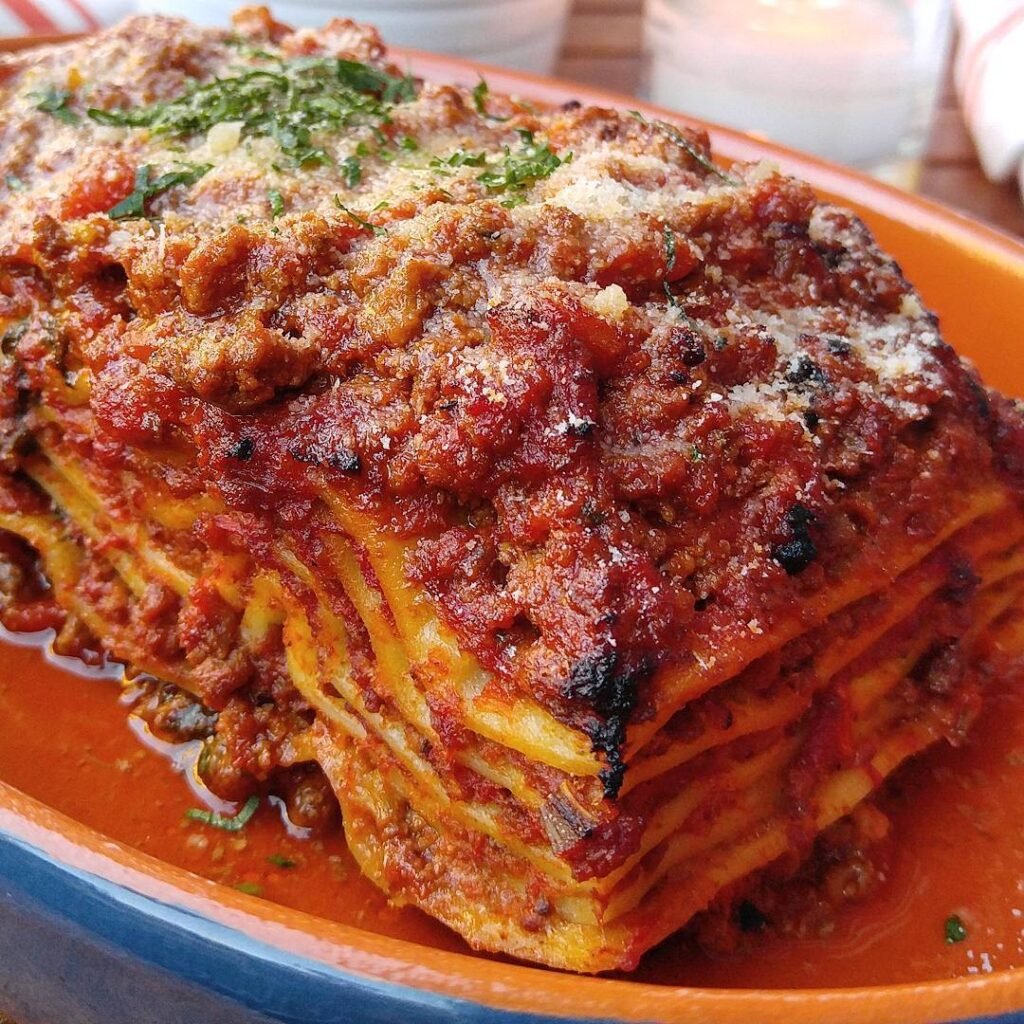 A delicious serving of classic Bolognese lasagna with layers of meat sauce, cheese, and pasta.