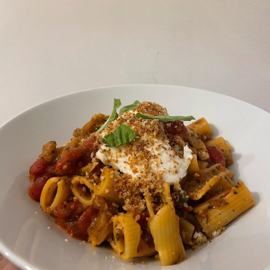 10 Delicious Vegetarian Pasta Recipes to Savor 10 A delicious Eggplant Parmesan Pasta Bake served with marinara sauce and topped with cheese.