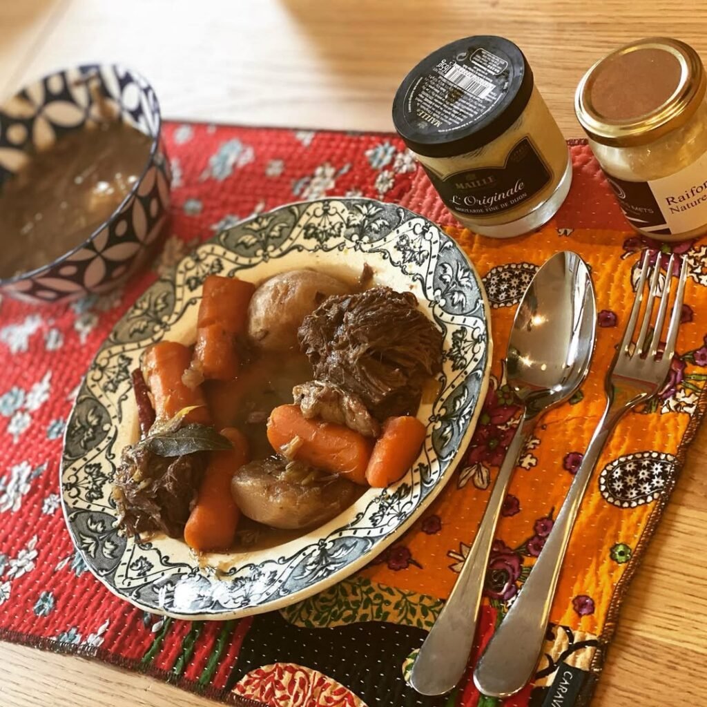 A pot of French Pot-au-Feu with root vegetables, showcasing chunks of meat and colorful vegetables in a rich broth.