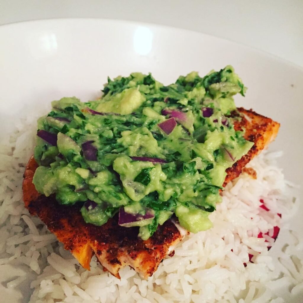 12 Delicious Birthday Dinner Recipes You’ll Love 2 Grilled salmon fillet topped with avocado salsa on a slate plate