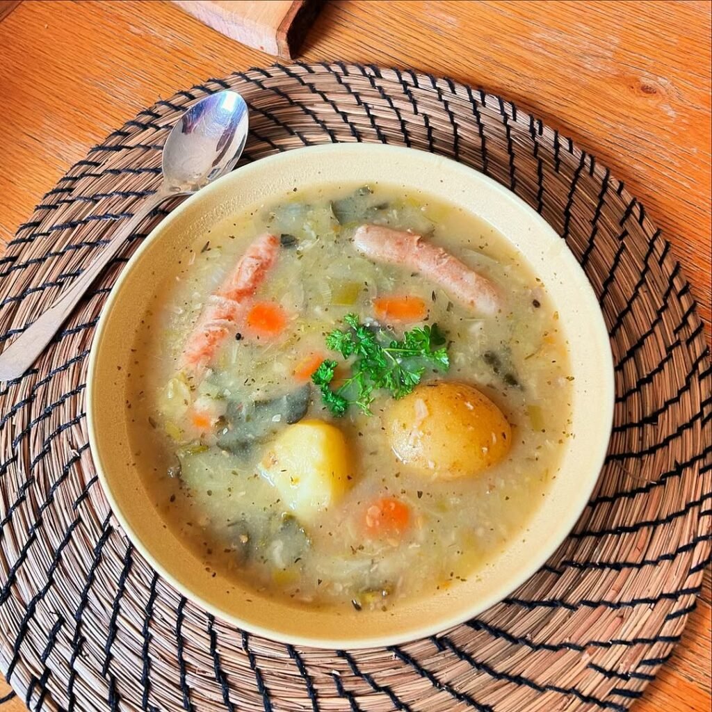 A cozy bowl of Irish Coddle with sausages, bacon, and potatoes.