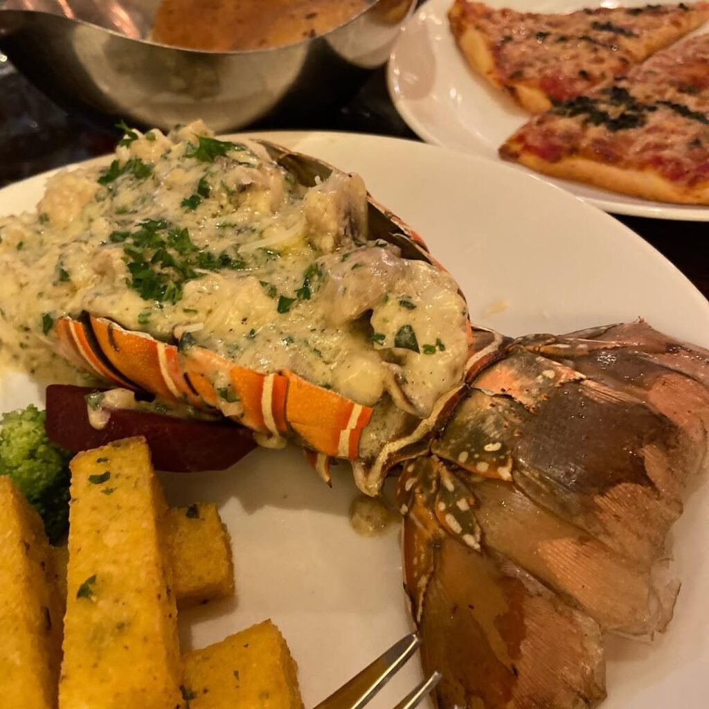 10 Lobster Dinner Recipes For A Taste Of Luxury 7 A beautifully presented Lobster Thermidor with creamy sauce, garnished with parsley and served in a shell.