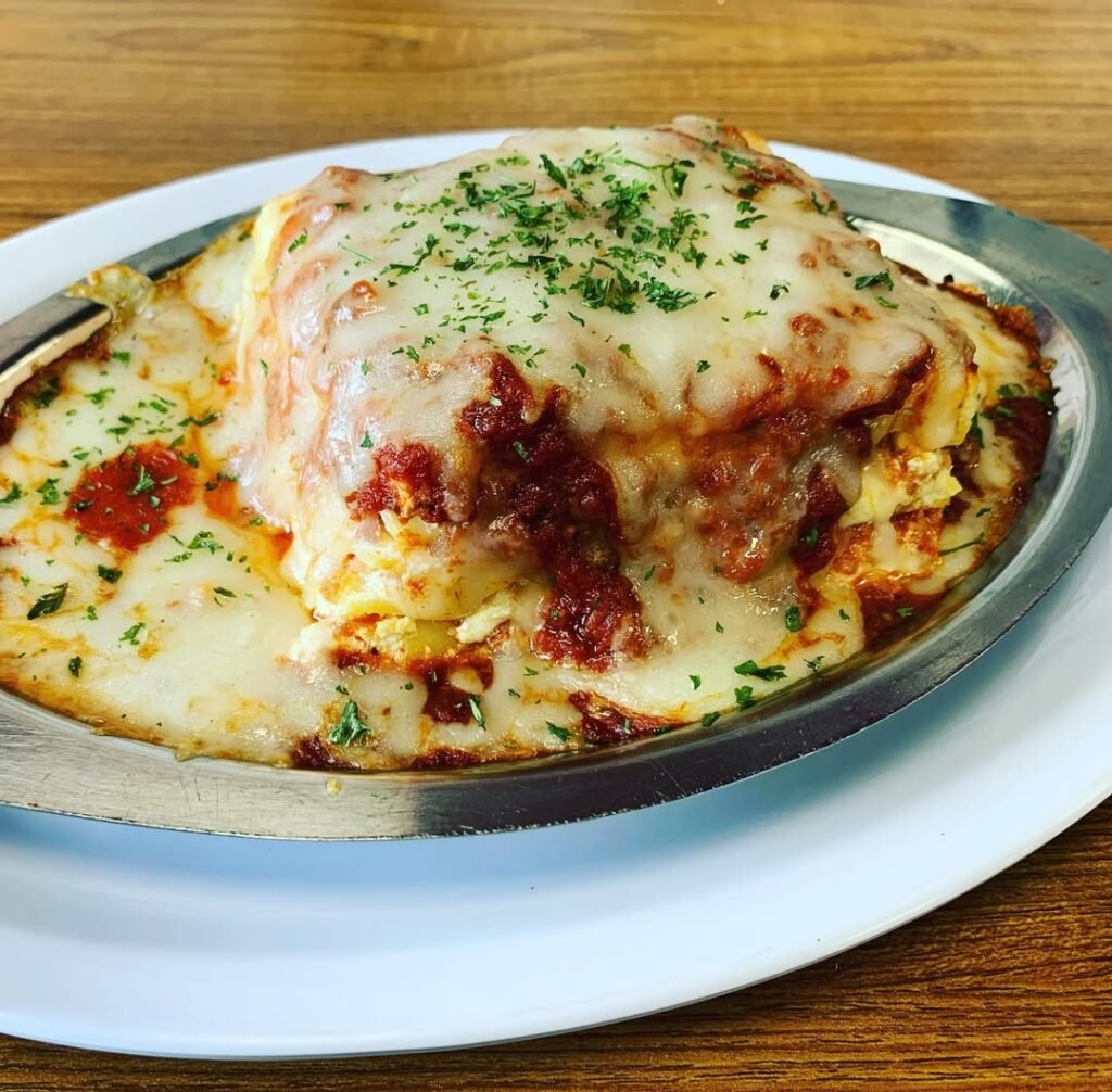 A plate of Mexican-inspired lasagna with spicy chorizo, topped with cilantro.