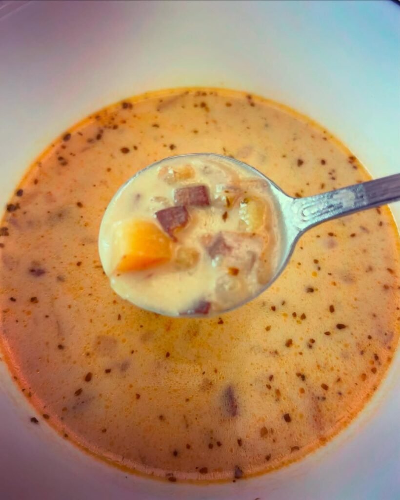 12 Creamy Potato Soup Recipes to Warm Your Soul 10 A bowl of creamy potato and corn chowder topped with fresh herbs.