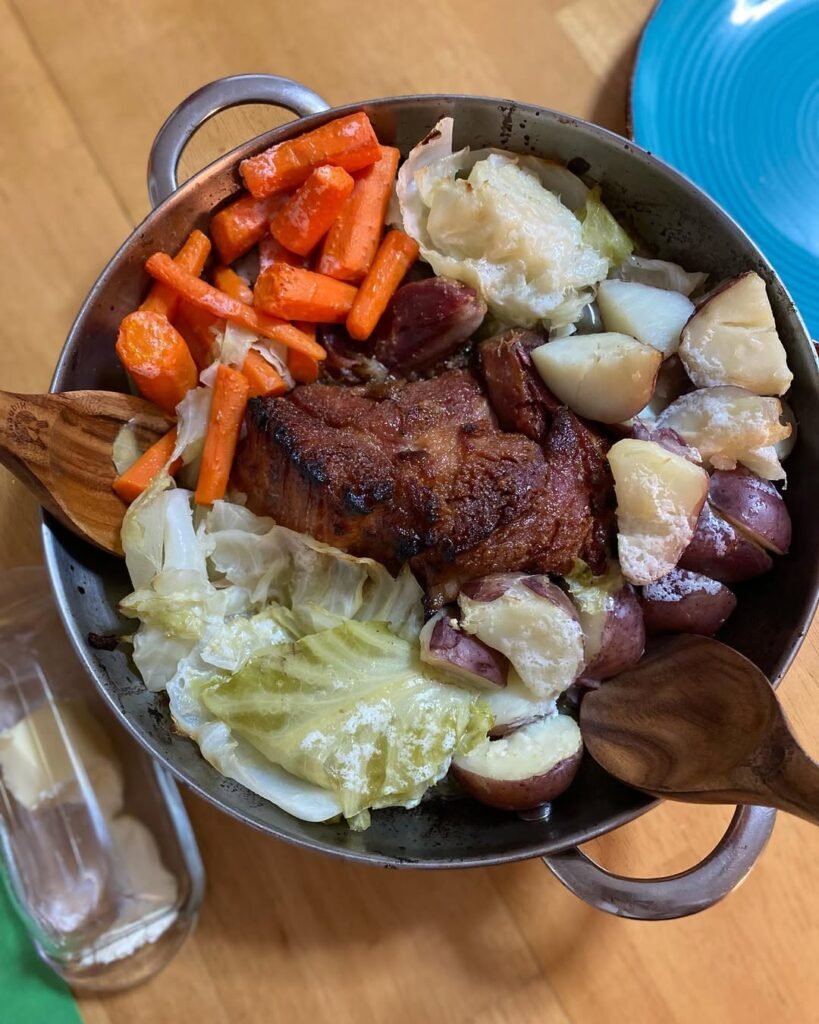 A hearty New England boiled dinner featuring corned beef and assorted vegetables.