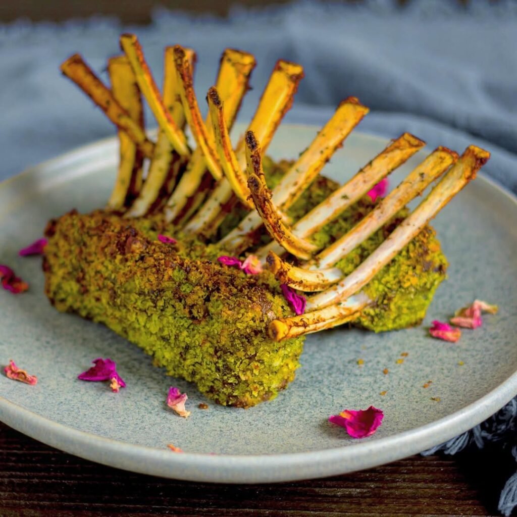 12 Delicious Birthday Dinner Recipes You’ll Love 8 A beautifully plated rack of lamb with a herb crust, garnished with rosemary.
