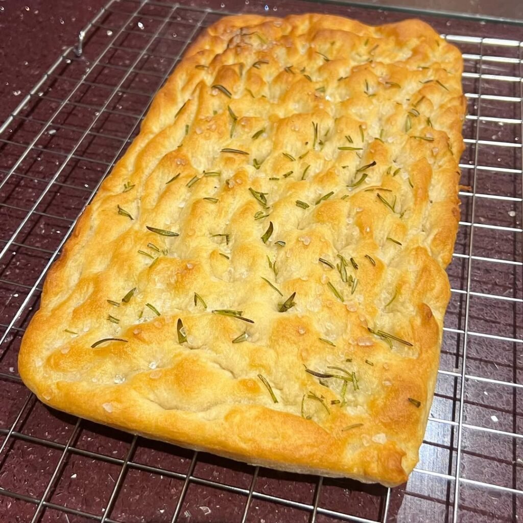 Rosemary and sea salt focaccia pizza on a wooden board