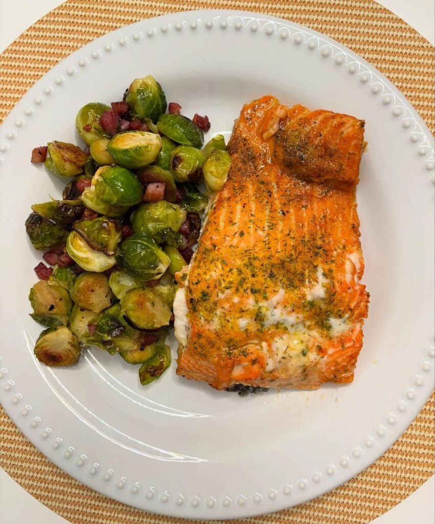 A plate of herbed salmon with roasted Brussels sprouts.