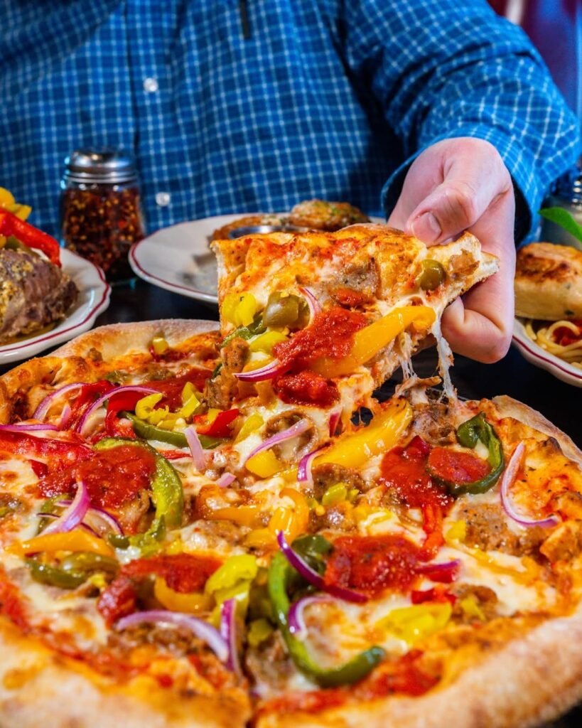 A delicious pizza topped with spicy sausage, colorful bell peppers, and melted cheese.