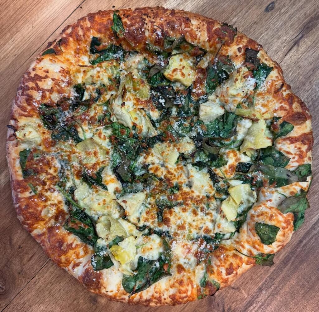 Creamy spinach and artichoke pizza with fresh ingredients