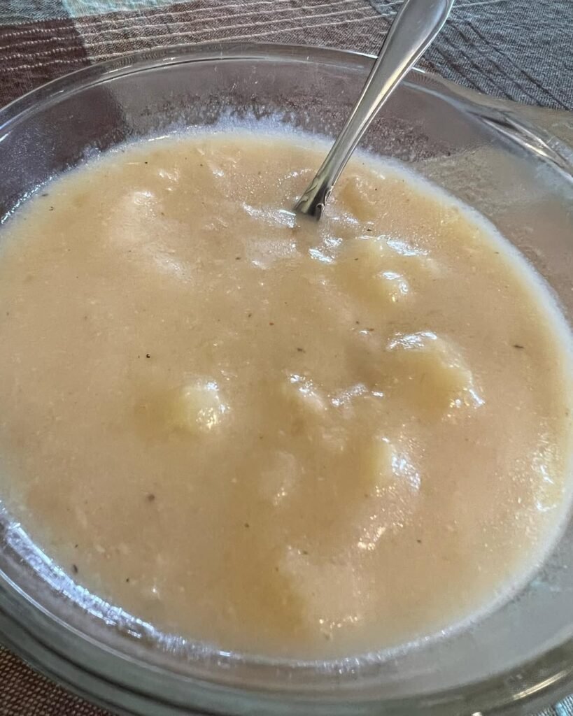 12 Creamy Potato Soup Recipes to Warm Your Soul 12 A bowl of creamy vegan potato soup garnished with avocado and herbs.