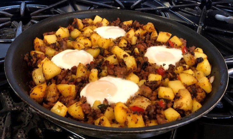 A delicious chorizo and potato hash topped with a sunny-side-up egg.