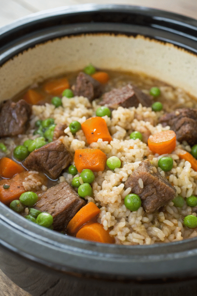 6 Easy and Nutritious Crockpot Recipes for Happy Dogs 3 A bowl of lamb and brown rice medley for dogs, featuring tender lamb chunks and brown rice.