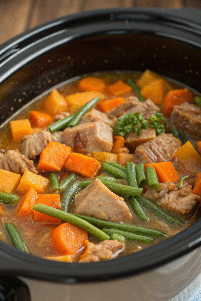 6 Easy and Nutritious Crockpot Recipes for Happy Dogs 6 A crockpot filled with pork and pumpkin dish surrounded by small pumpkins.